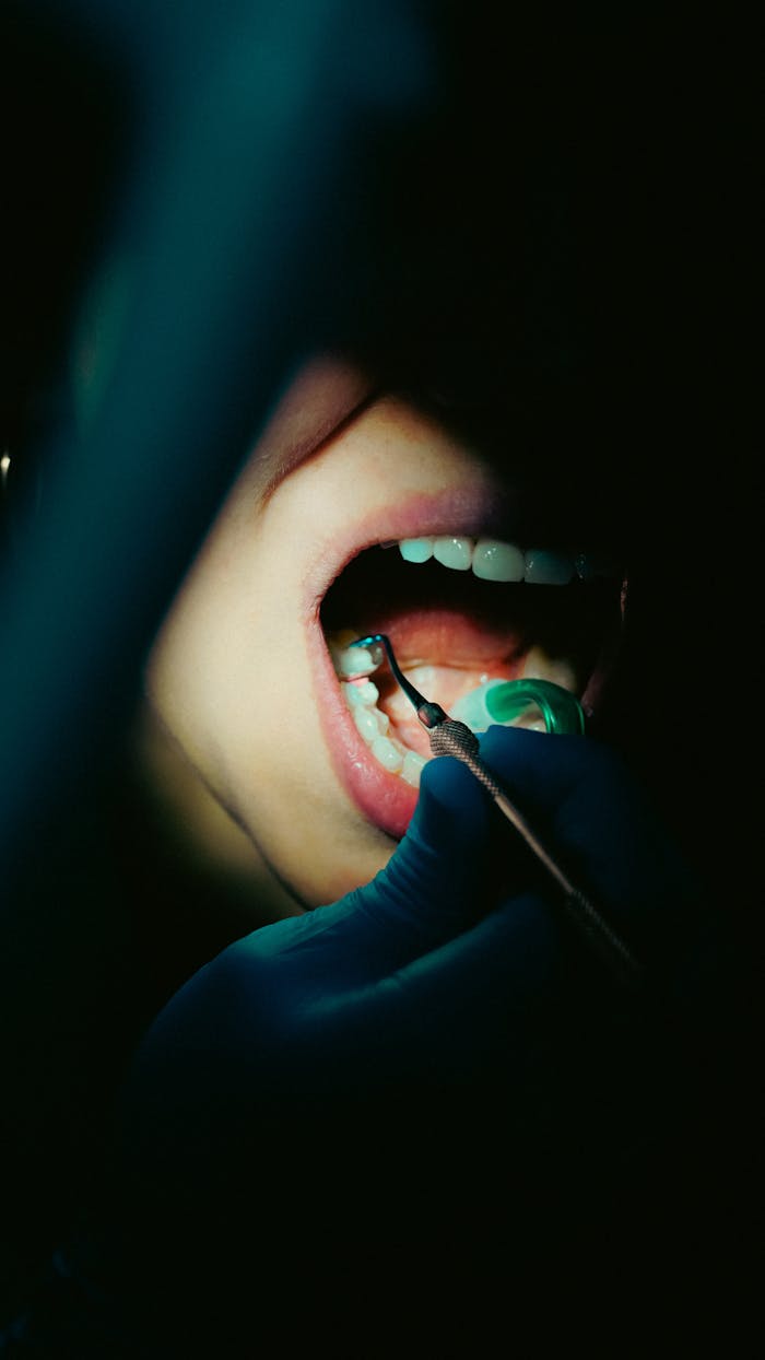 about-us-02 Detailed close-up of a dental examination with dental tools, showcasing oral hygiene.